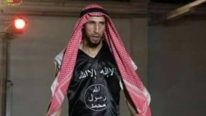 In an image released by Italian police, Abderrahim Moutaharrik is seen a keffiyeh and a black shirt styled after the IS flag. (Italian Police)
